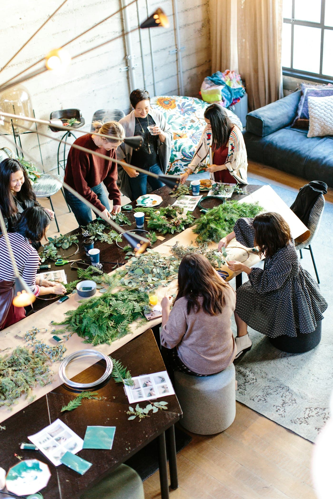 Adults at long tables in a hands-on workshop, seen from above