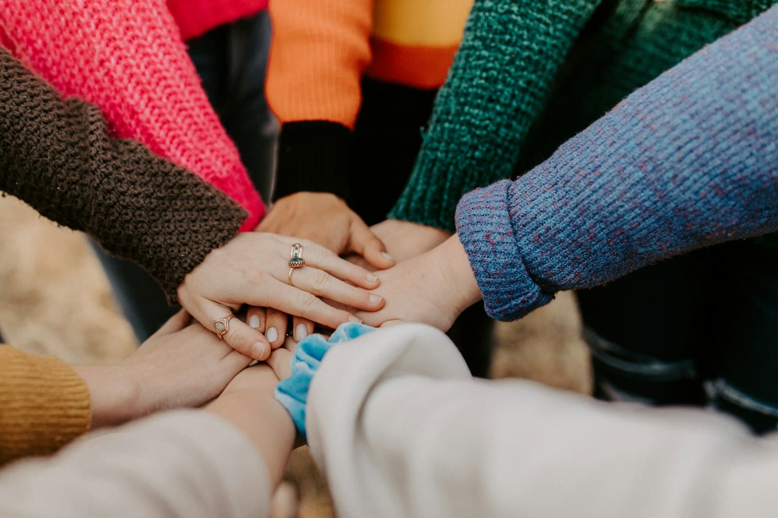 A group of people stacking their hands together
